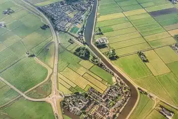 aerial photograph of village eside river